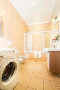 a bathroom with a washing machine and a sink at Flatlux Apartments in Kyiv
