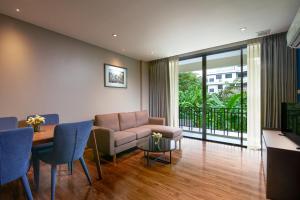 a living room with a couch and a table at Amp Am House Bangkok Hotel in Bangkok