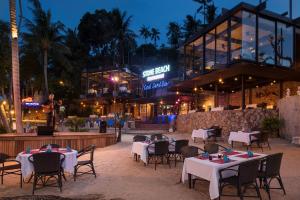a restaurant with tables and chairs in front of a building at Panviman Resort Koh Phangan - SHA Extra Plus in Thong Nai Pan Noi