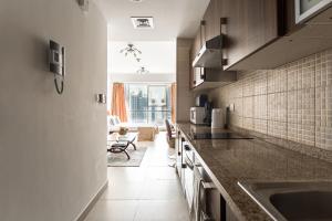 a kitchen with a sink and a large window at Frank Porter - Goldcrest Executive in Dubai