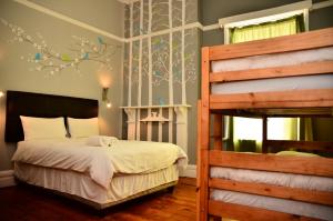 a bedroom with a bed and a bunk bed at Big Blue Backpackers in Cape Town