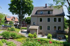 a house with a garden in front of it at StrandBerg's Harzchalet in Braunlage
