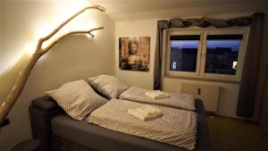 1 dormitorio con 1 cama con 2 toallas en Holzmichel FEWO mit Balkon en Cottbus