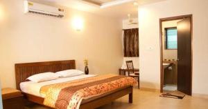 a bedroom with a bed in a room at Paradise Villas & Resort in Alibaug