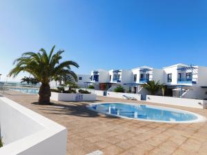 a view of a resort with a swimming pool and buildings at Las Moreras Playa Blanca in Playa Blanca