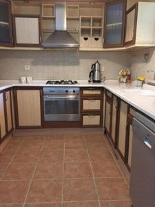 a kitchen with wooden cabinets and a stove top oven at Villa SD Sapanca in Sapanca