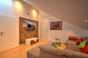 a living room with two couches and a tv at Ferienwohnung"VIP MUNICH ALBATROS DE LUXE" in Kirchheim
