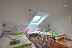 a room with two beds and a table and a window at Ferienwohnung"VIP MUNICH ALBATROS DE LUXE" in Kirchheim