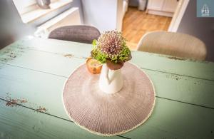 a vase with a plant in it sitting on a table at P13 in Erfurt