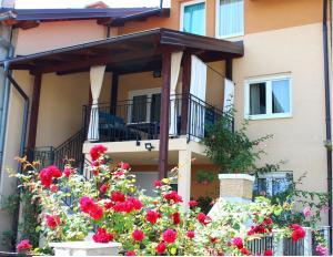 a house with flowers in front of it at Olad Riverview Townhouse in Sarajevo