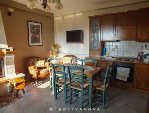a kitchen with a table and chairs in a room at Guesthouse Paralimnia in Kalyvia