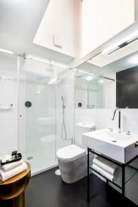 a bathroom with a shower and a toilet and a sink at The A5 Smart Luxury Studios in Porto +35 photos