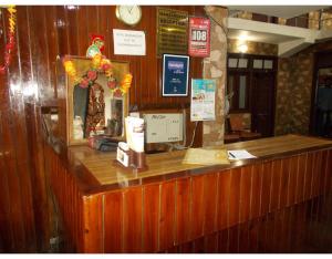a counter in a restaurant with a clock on the wall at Hotel Mansarovar Palace in Mussoorie