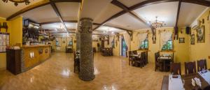 a restaurant with a column in the middle of a room at Stara Vezha Hotel in Boryspilʼ