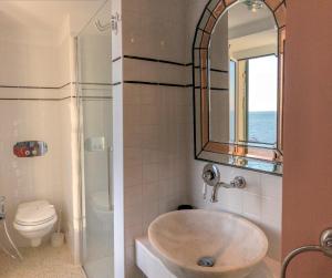 a bathroom with a sink, toilet and bathtub at Agave Room Rental in Riomaggiore