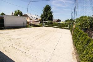a tennis court in front of a fence at Penzion-Cukroška in Hlušovice