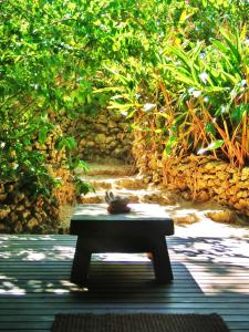 a bench sitting in the middle of a patio at Taketomijima Akaneya in Taketomi