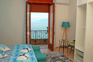 a room with a bed and a view of the ocean at Piana delle Galee in Scilla