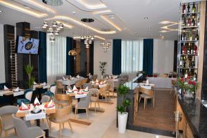 a restaurant with tables and chairs in a room at Hotel Prezident in Ivanjica