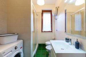 a bathroom with a sink and a washing machine at Sweet Home La Ville in Caserta +15 photos