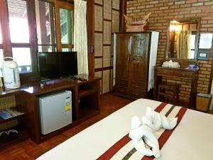a room with a bed with a towel on it at Marisa Resort & Spa Chiang Dao in Ban Muang Ngai