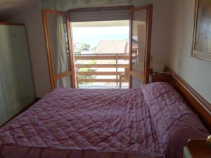 Postel nebo postele na pokoji v ubytování Hotel Michela