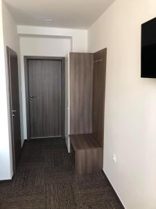a room with a closet with a door and a television at Penzion Teplanka in Považská Bystrica