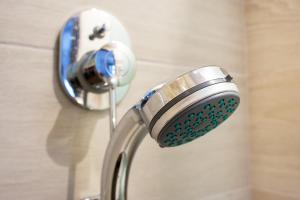 a shower faucet in a bathroom with a shower at Sea La Vie - Studios Maria in Limenaria