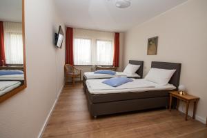 Postel nebo postele na pokoji v ubytování Hotel Janssen