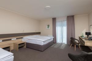 Posteľ alebo postele v izbe v ubytovaní Hotel Panská Zahrada