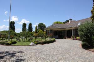 a house with a stone driveway in front of it at Historic Merryville Homestead in Murrumbateman