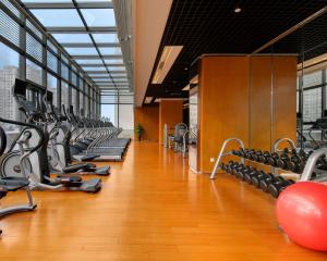 a gym with rows of treadmills and exercise equipment at Marco Polo Parkside, Beijing in Beijing