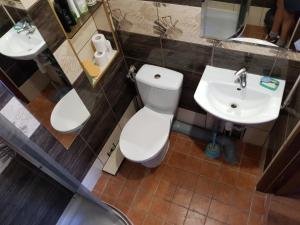 a bathroom with a toilet and a sink at Małgorzata Pokoje in Sopot