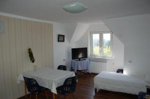 a room with two beds and a table and a window at Małgorzata Pokoje in Sopot +13 photos