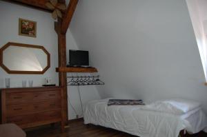 a bedroom with a bed and a mirror and a dresser at Małgorzata Pokoje in Sopot