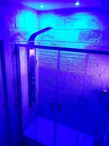 a bathroom with a blue and purple lighting at Room n.22 in Taranto +9 photos