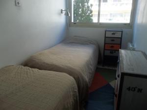 Ένα ή περισσότερα κρεβάτια σε δωμάτιο στο Appartement Front de Mer avec Piscine