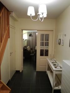 a kitchen with a hallway with a living room at Vakantiehuis in Knokke-Heist met tuin en parkeerplaats in Knokke-Heist