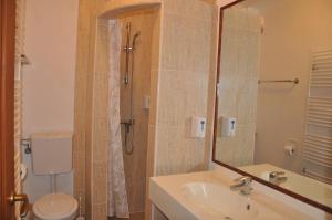 a bathroom with a sink and a toilet and a mirror at Pensiune Muzeu Traditional Poveste in Transilvania in Sighişoara +44 photos