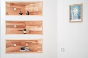 two views of a wooden shelf in a room at Alt Apartament in Sibiu +10 photos