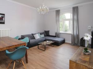 a living room with a couch and a table at City Apartments Siegburg in Siegburg
