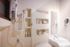 a bathroom with a shower and a toilet and a sink at Narra House Sukhumvit58 in Bangkok +53 photos