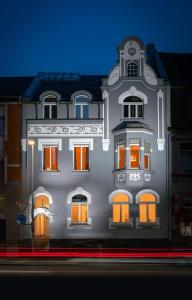 a large building with orange windows on a street at City Apartments Siegburg Studios in Siegburg