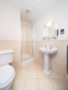 a bathroom with a toilet and a sink and a shower at Lobster Hall - Room Only in Whitby