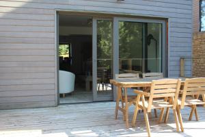 a wooden table and chairs on a patio at Les hauts de Meez in Dinant