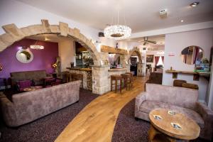 a living room with couches and a stone fireplace at Twin Oaks Hotel in Chesterfield