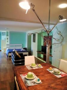 a living room with a table and a bed at Zaffiro Blu Airport in Bergamo