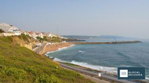 a road next to the ocean with a beach at Casa Ouriceira, Centro Ericeira in Ericeira