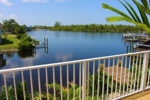 a view of a river with a white railing at Latitude 26 Waterfront Boutique Resort - Bonita Springs in Bonita Springs