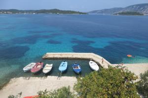 a group of boats sitting in the water at I&J Relaxing Beach Apartments in Račišće